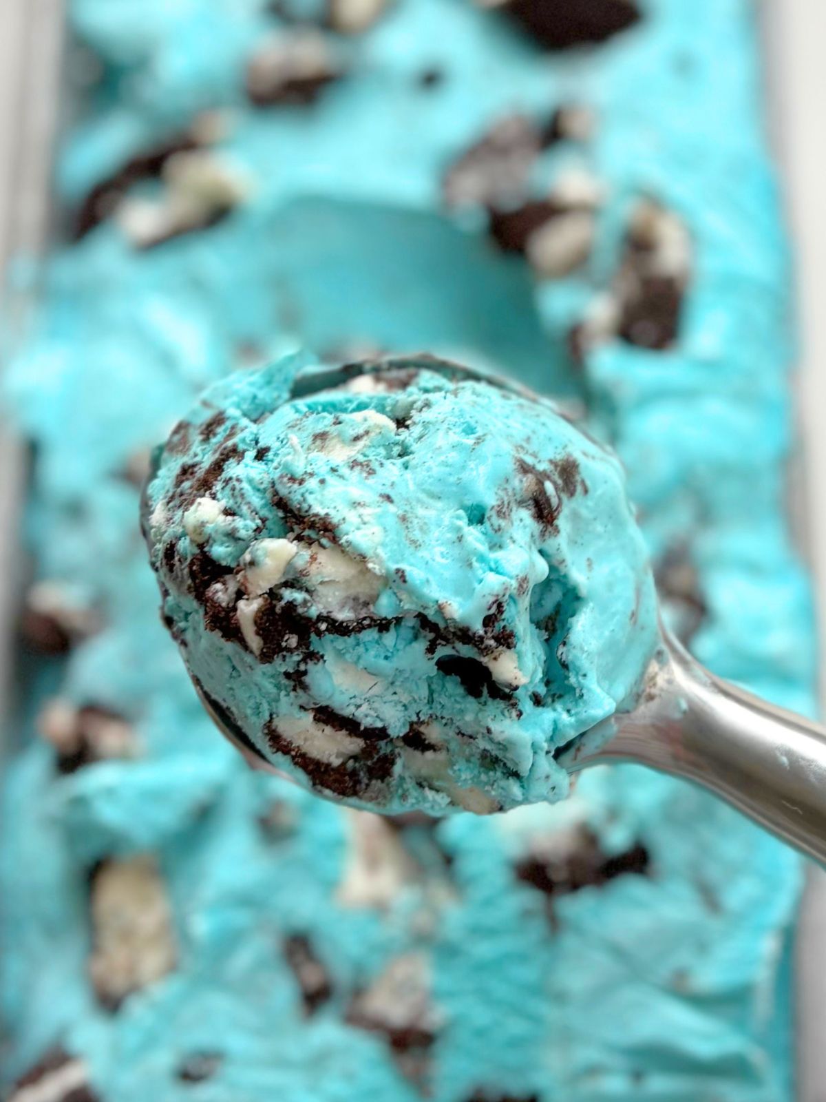 a scoop of blue oreo ice cream in an ice cream scooper