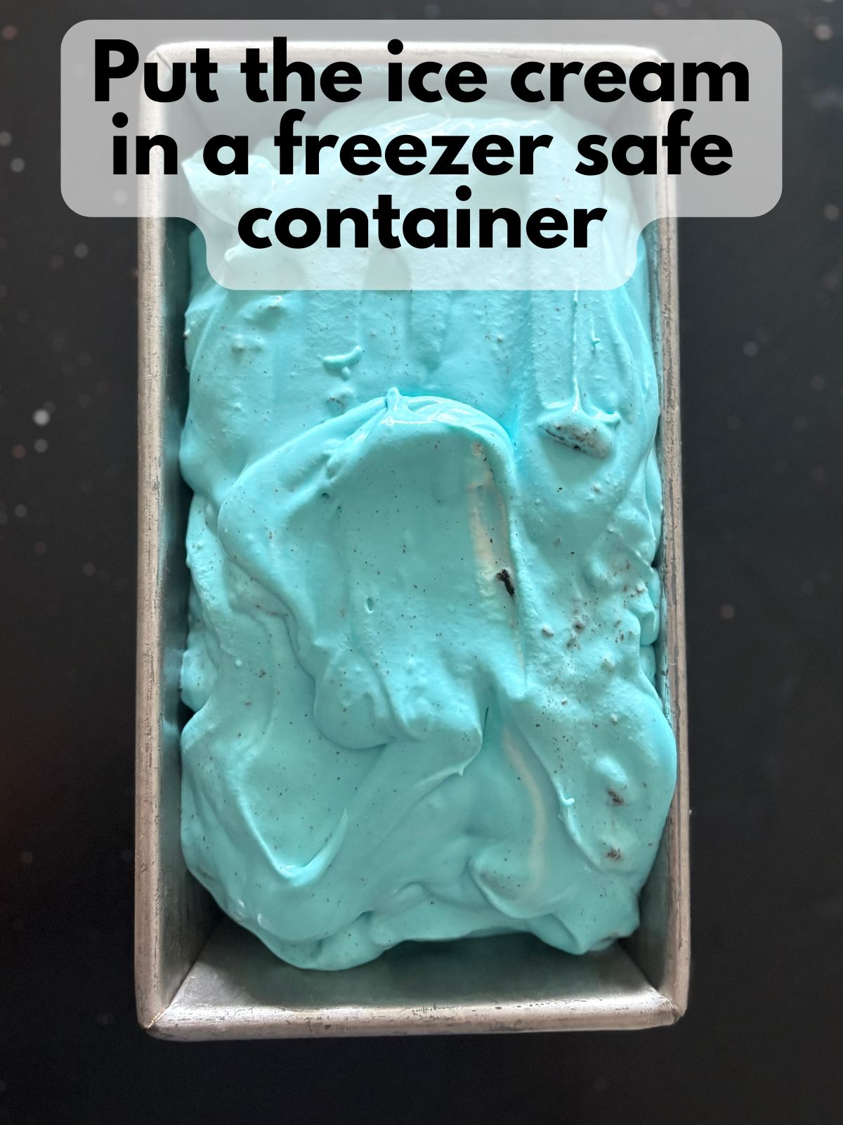 blue oreo ice cream poured in a loaf pan