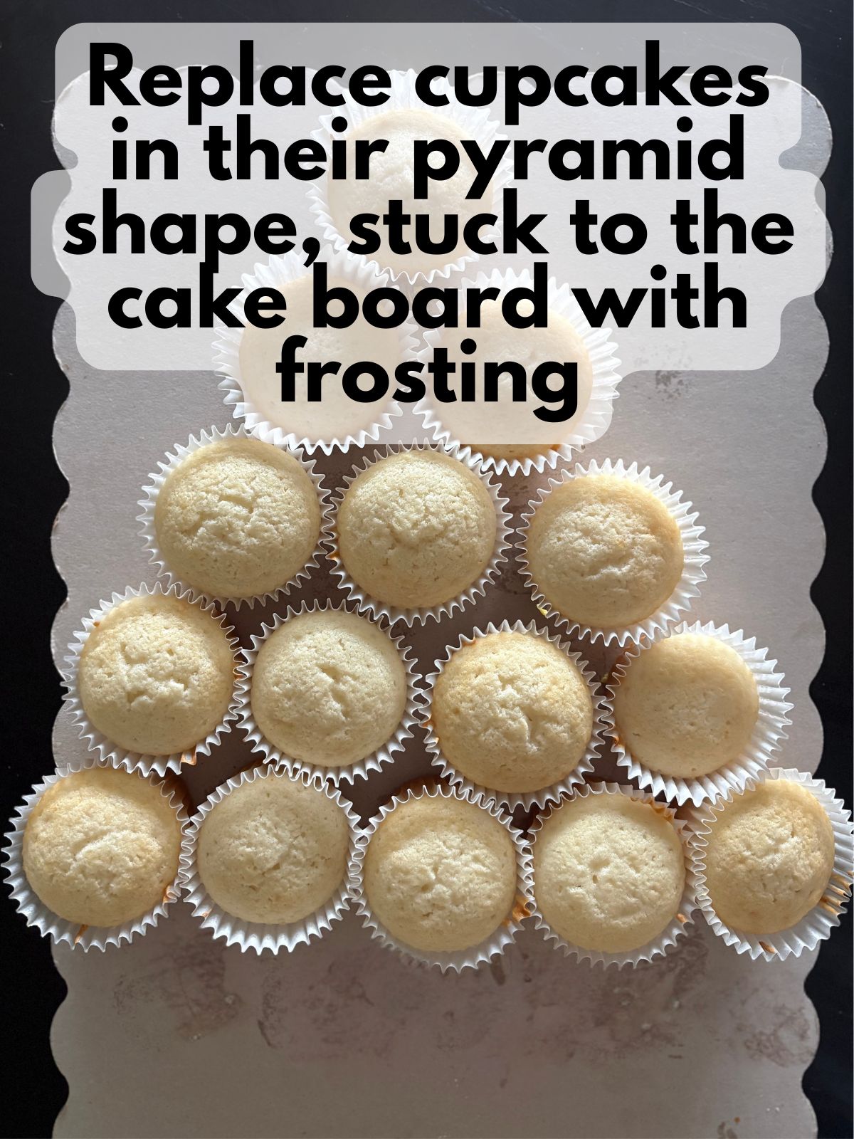 cupcakes arranged in the shape of a piece of candy corn on a cake board