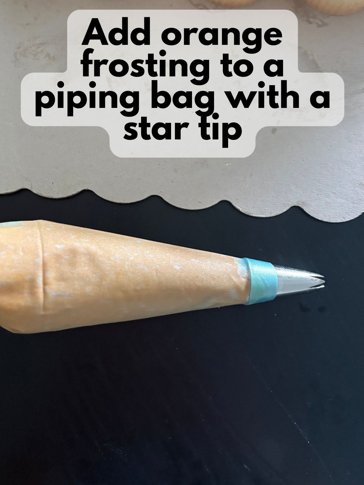 orange frosting in a piping bag with a star rip