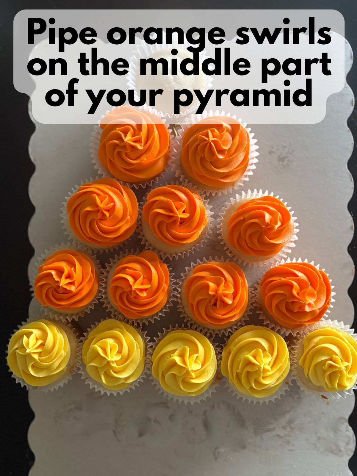 orange frosting piped over the middle cupcakes in the cupcake cake