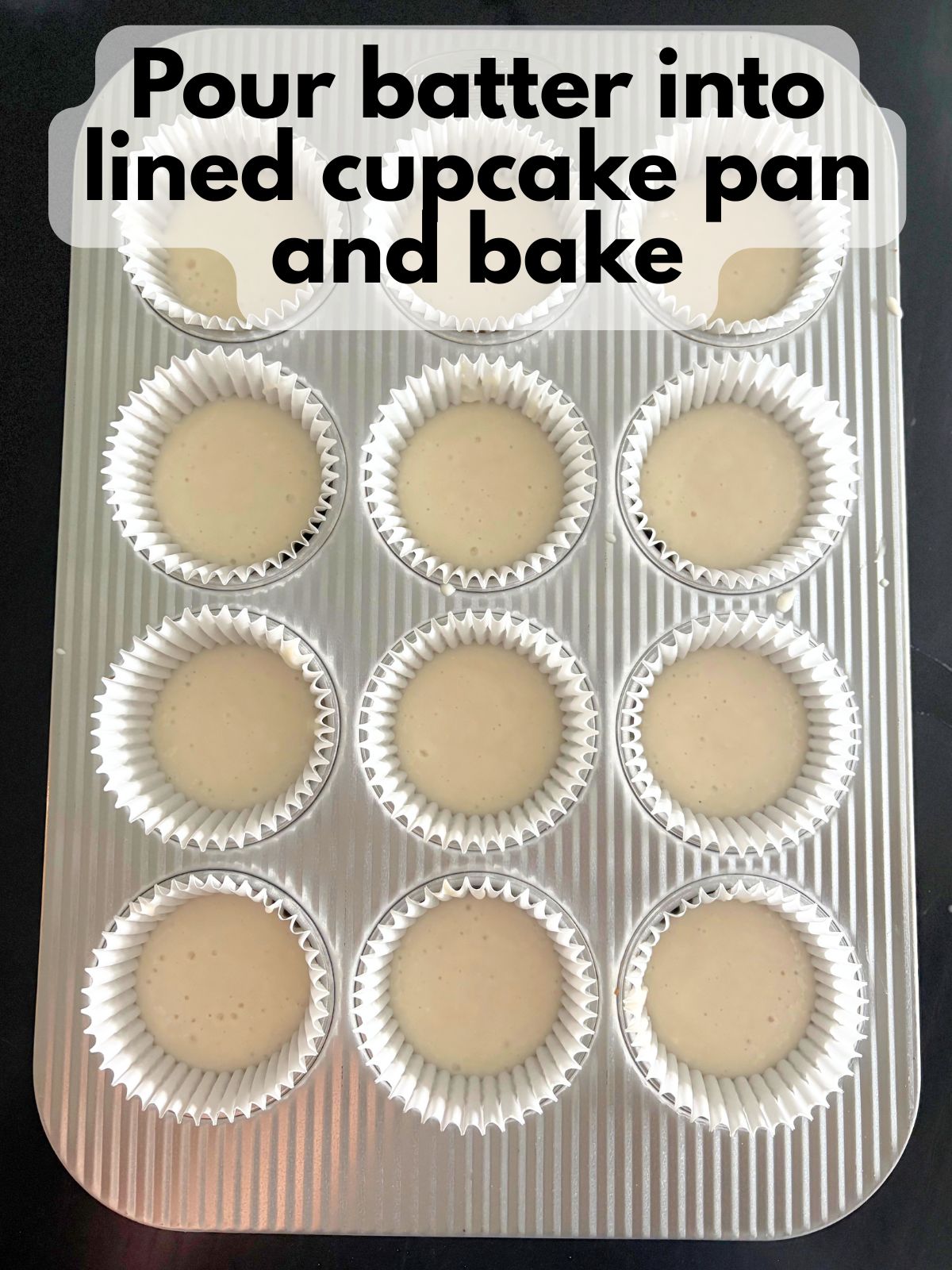 cupcake batter in a lined cupcake pan