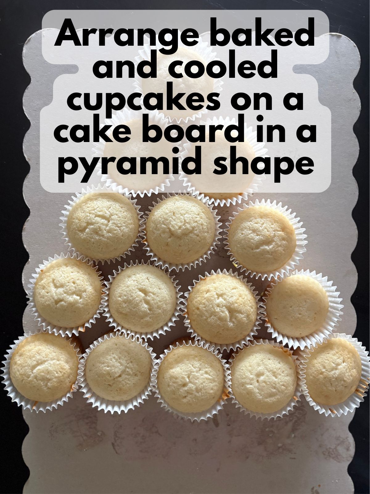 cupcakes arranged in the shape of a piece of candy corn on a cake board