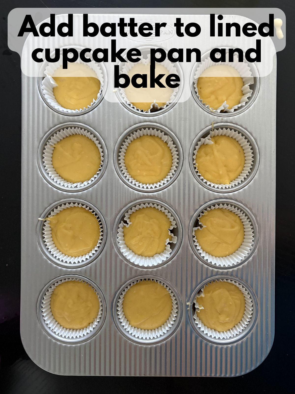 yellow cupcake batter in cupcake pan