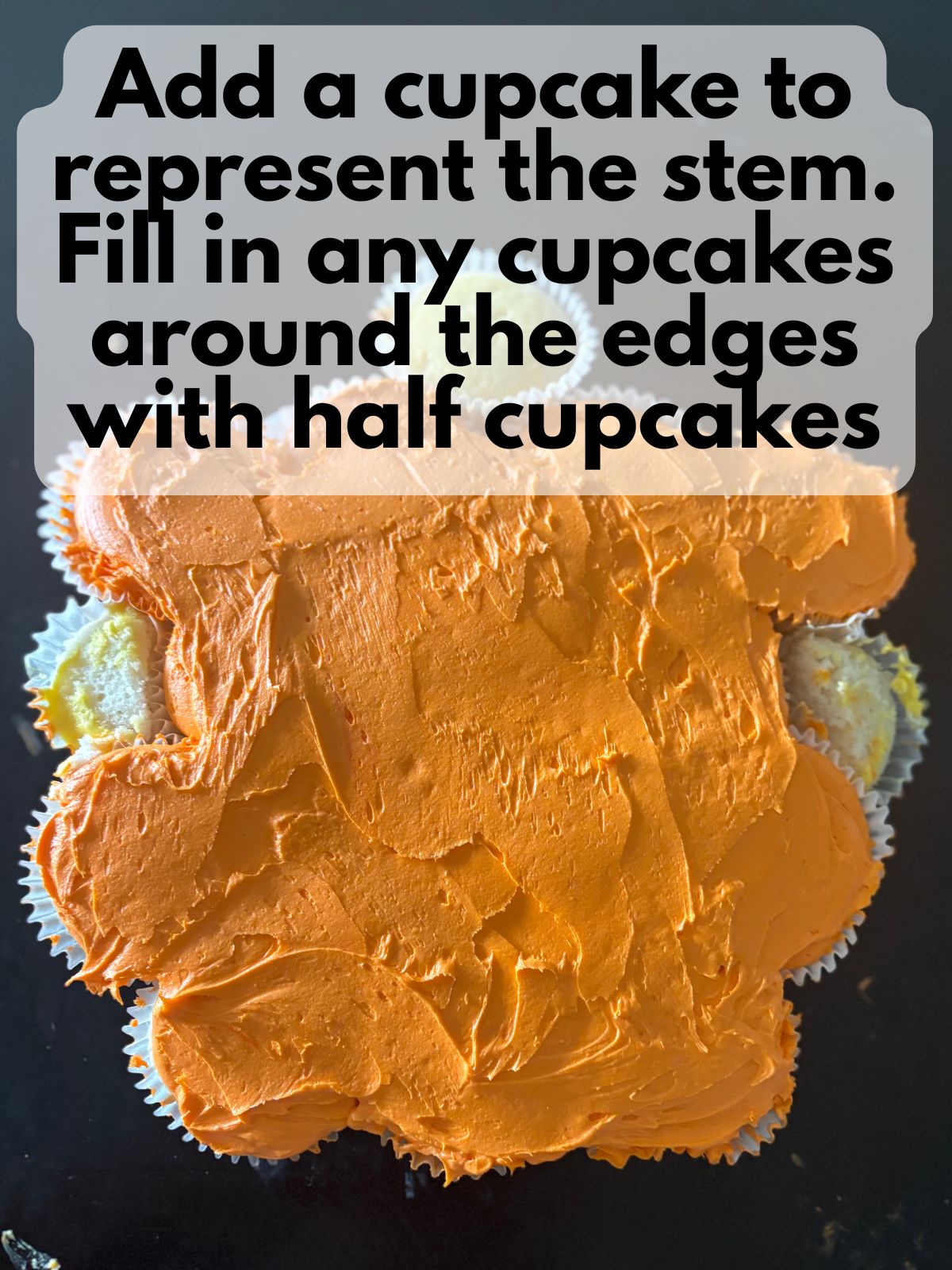 extra cupcakes placed to fill in the gaps on the jack-o-lantern cupcake cake and an extra cupcake for the stem