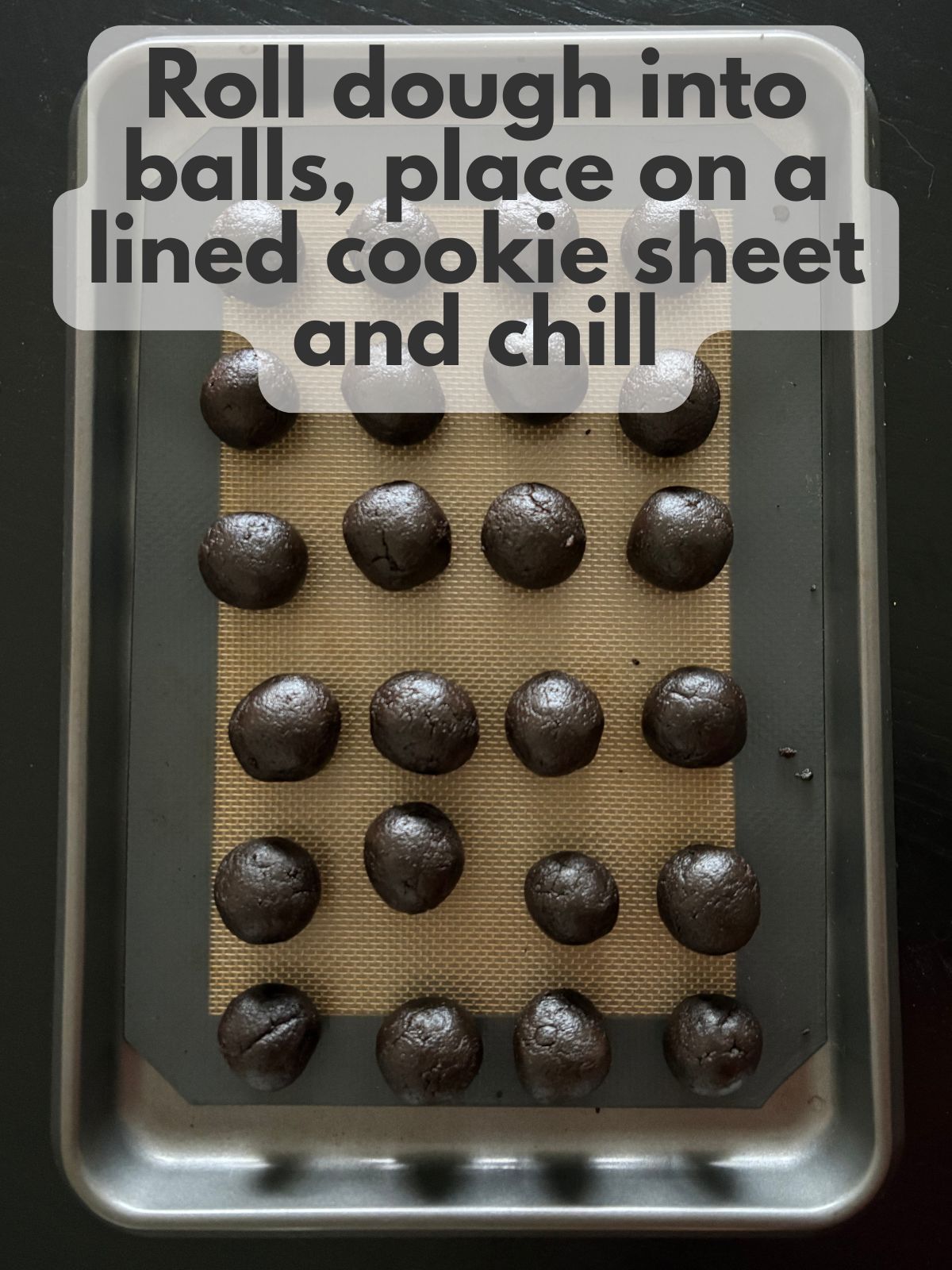 oreo balls on a lined cookie sheet
