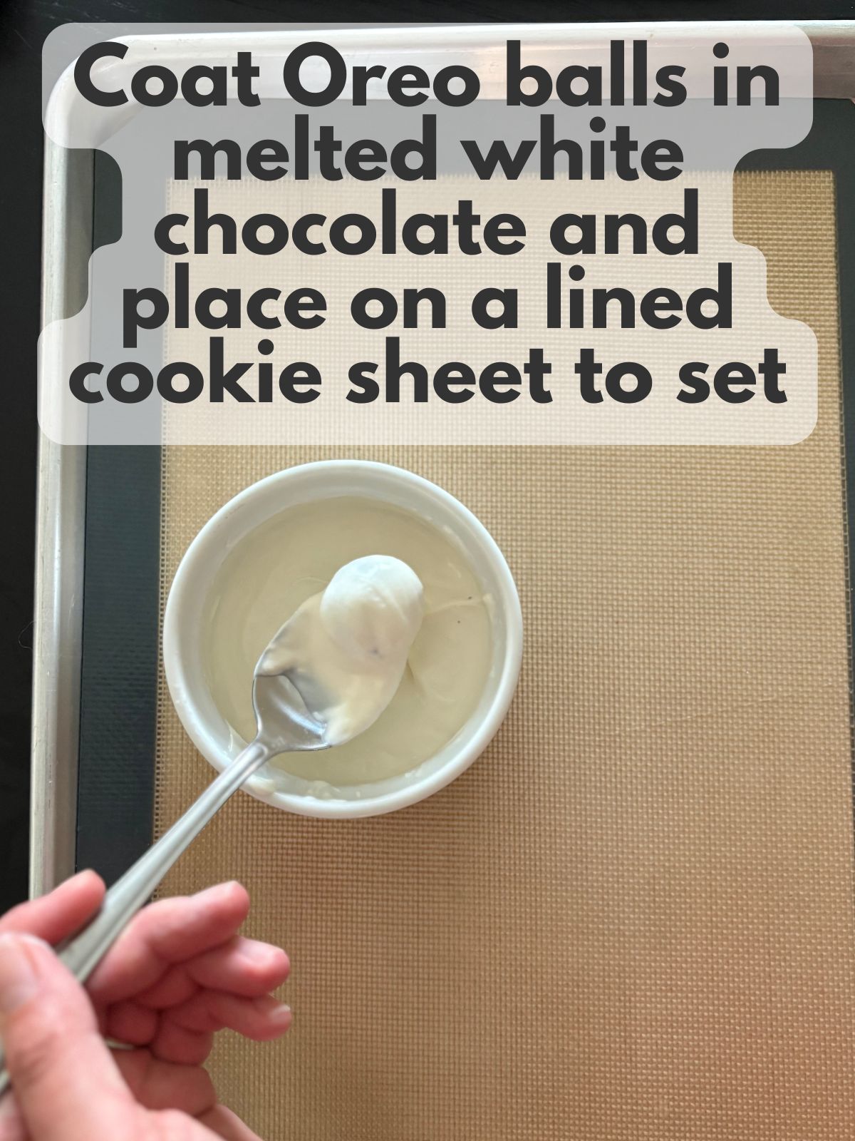 oreo ball being coated in melted white chocolate