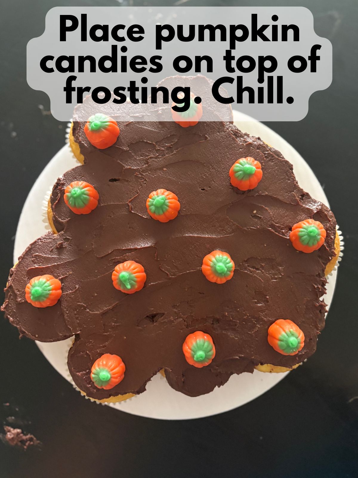 pumpkin candies on top of frosted cupcake cake