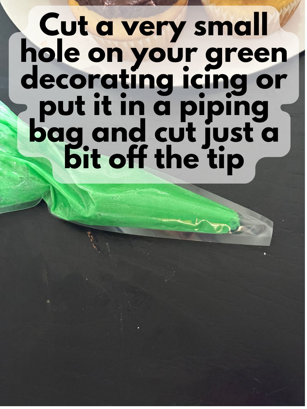 green frosting in a piping bag with a very small tip cut off