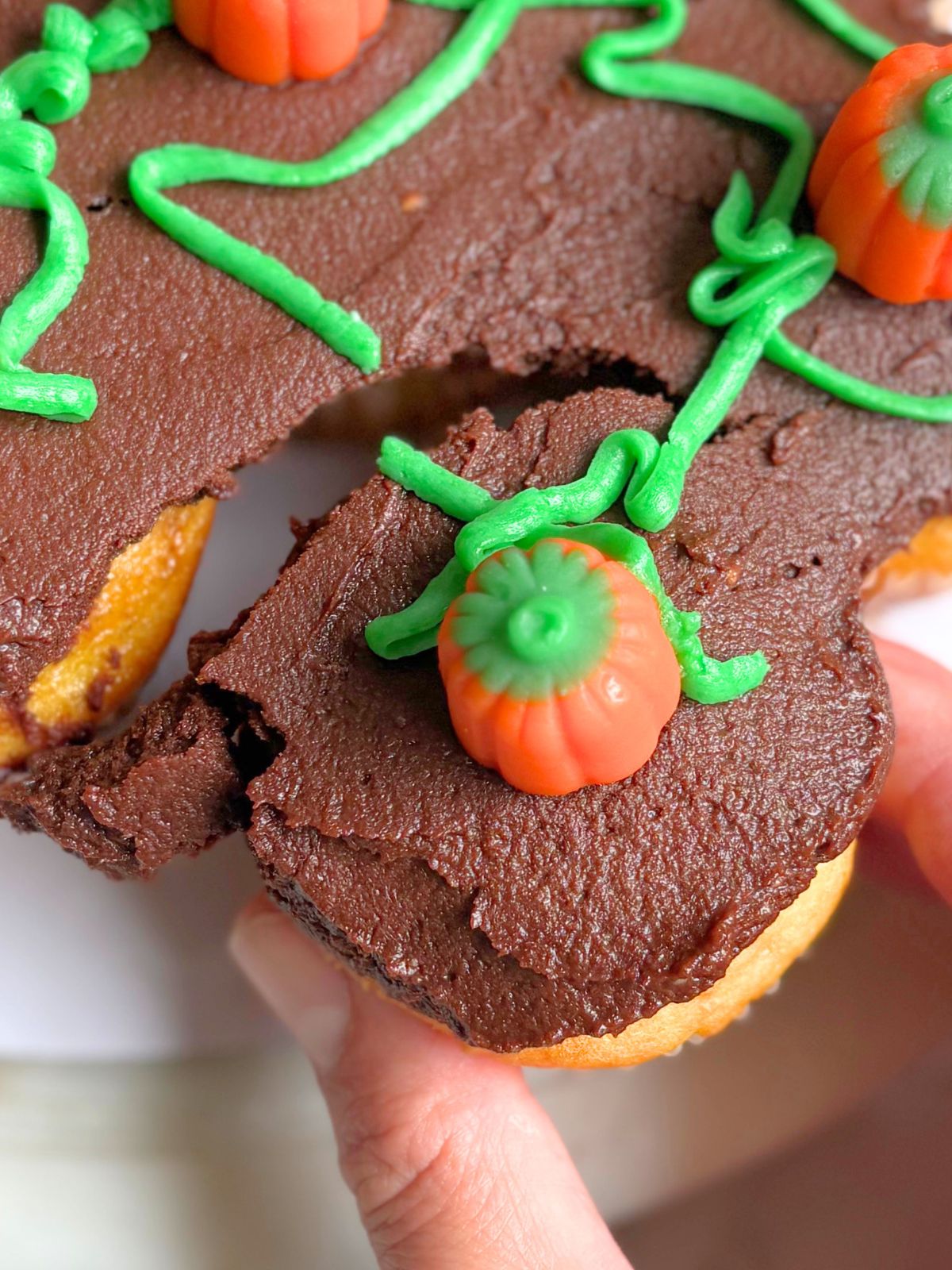 a cupcake being pulled away from the pull-apart pumpkin patch cake