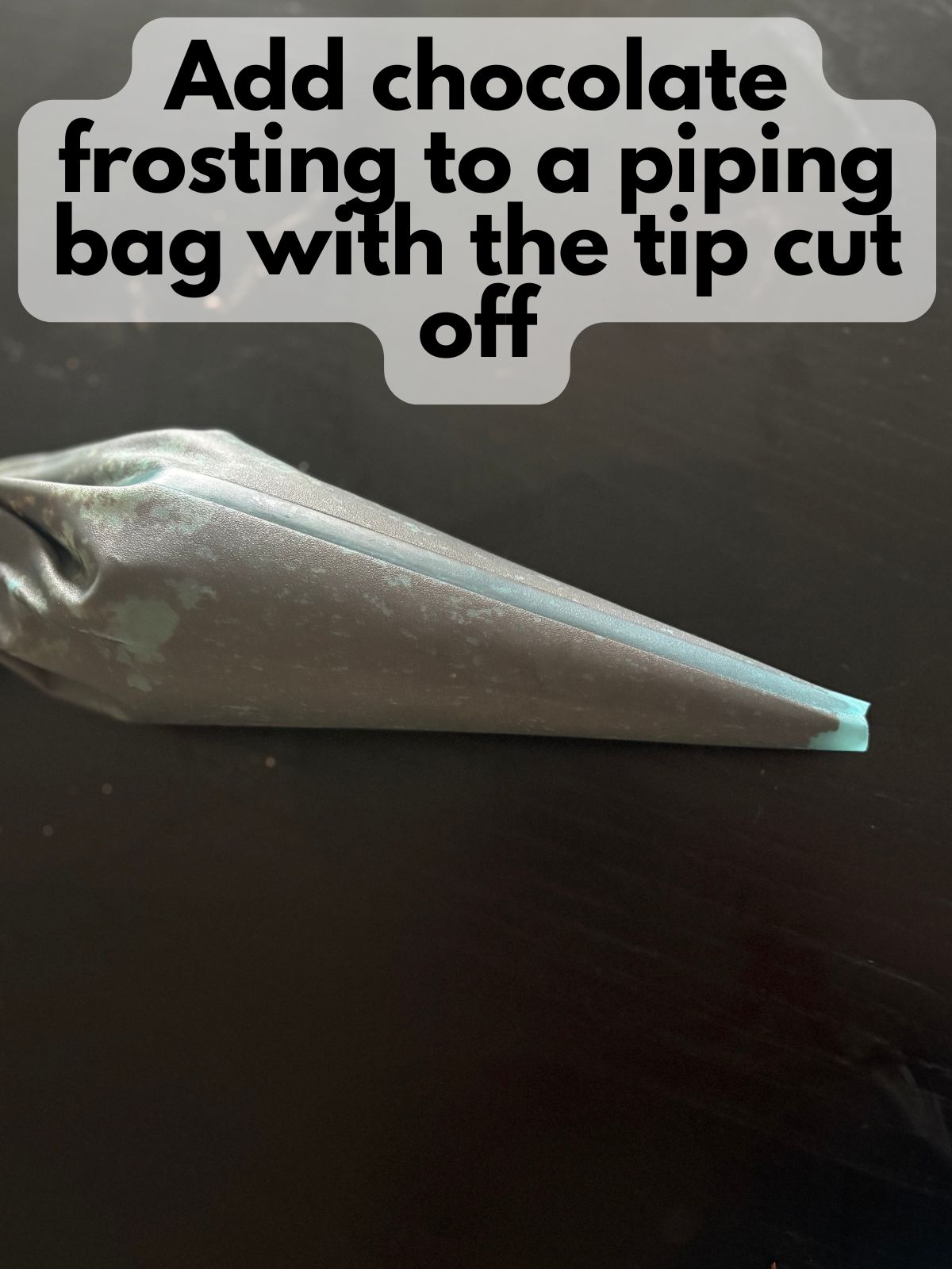 chocolate frosting in a reusable piping bag with a larger tip cut off