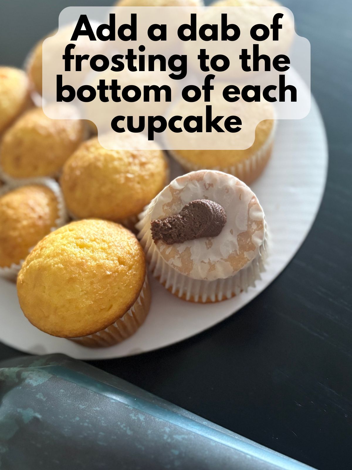 chocolate frosting dabbed on the bottom of a cupcake