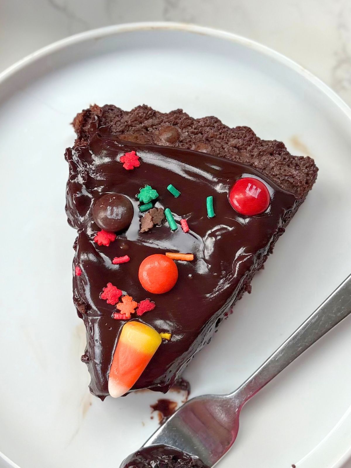 a slice of thanksgiving brownie pizza on a plate
