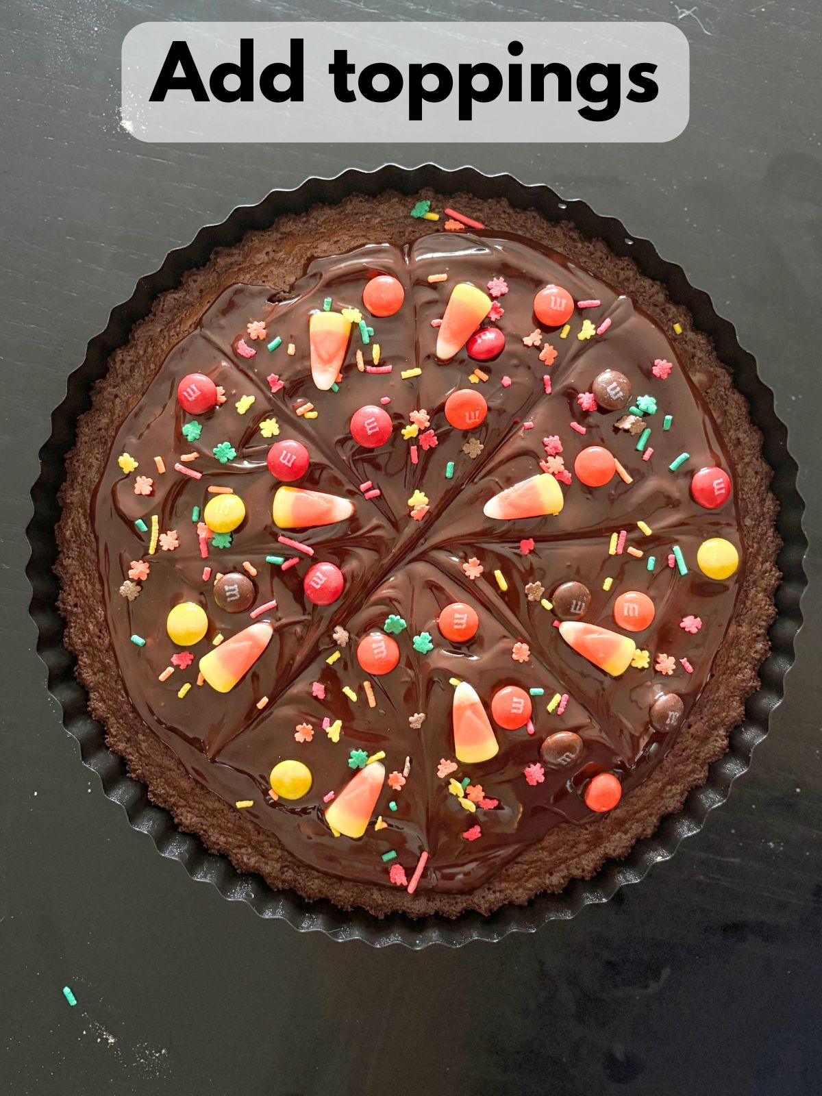 toppings sprinkled on top of chocolate ganache