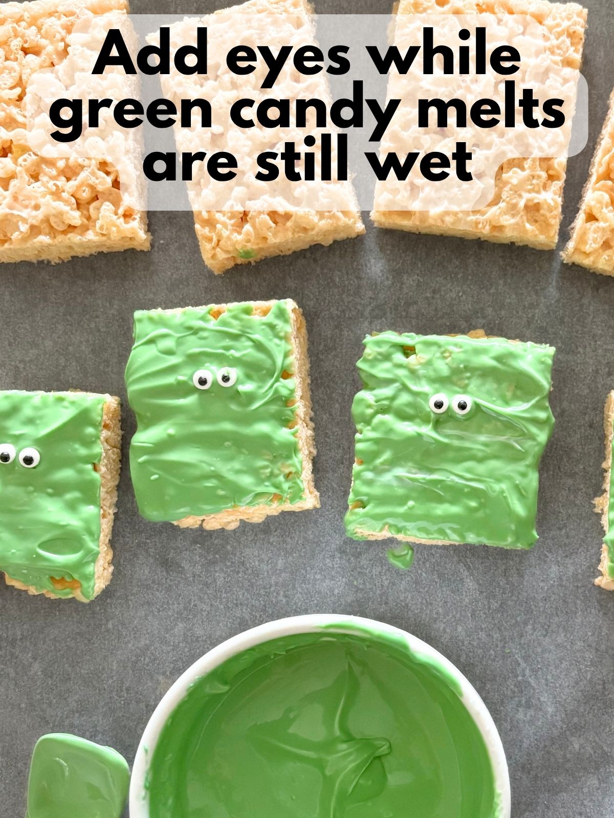 eyes placed on rice krispie treats dipped in green candy melts