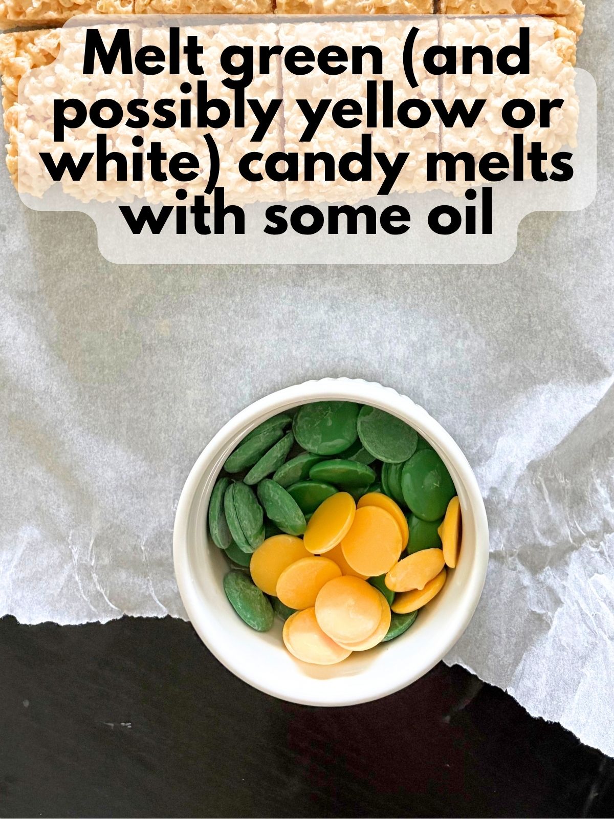 mostly green and a few yellow candy melts in a bowl with some vegetable oil