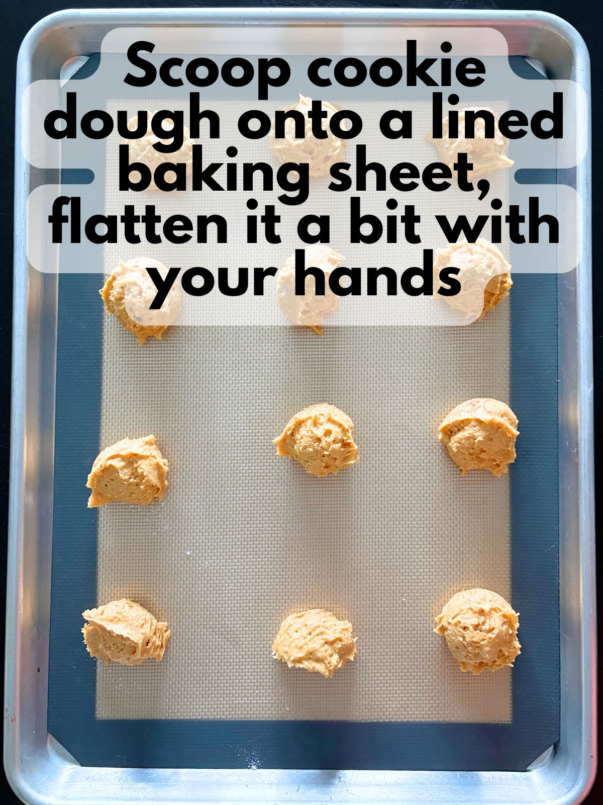 pumpkin cake mix cookie dough on a lined baking sheet
