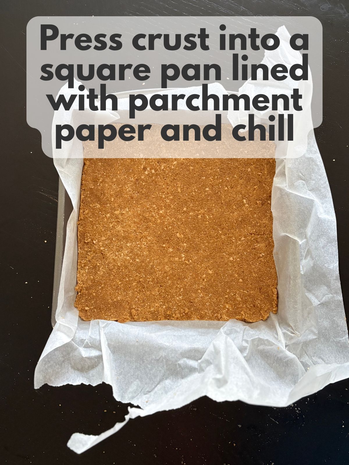 graham cracker crust pressed into a square pan lined with parchment paper