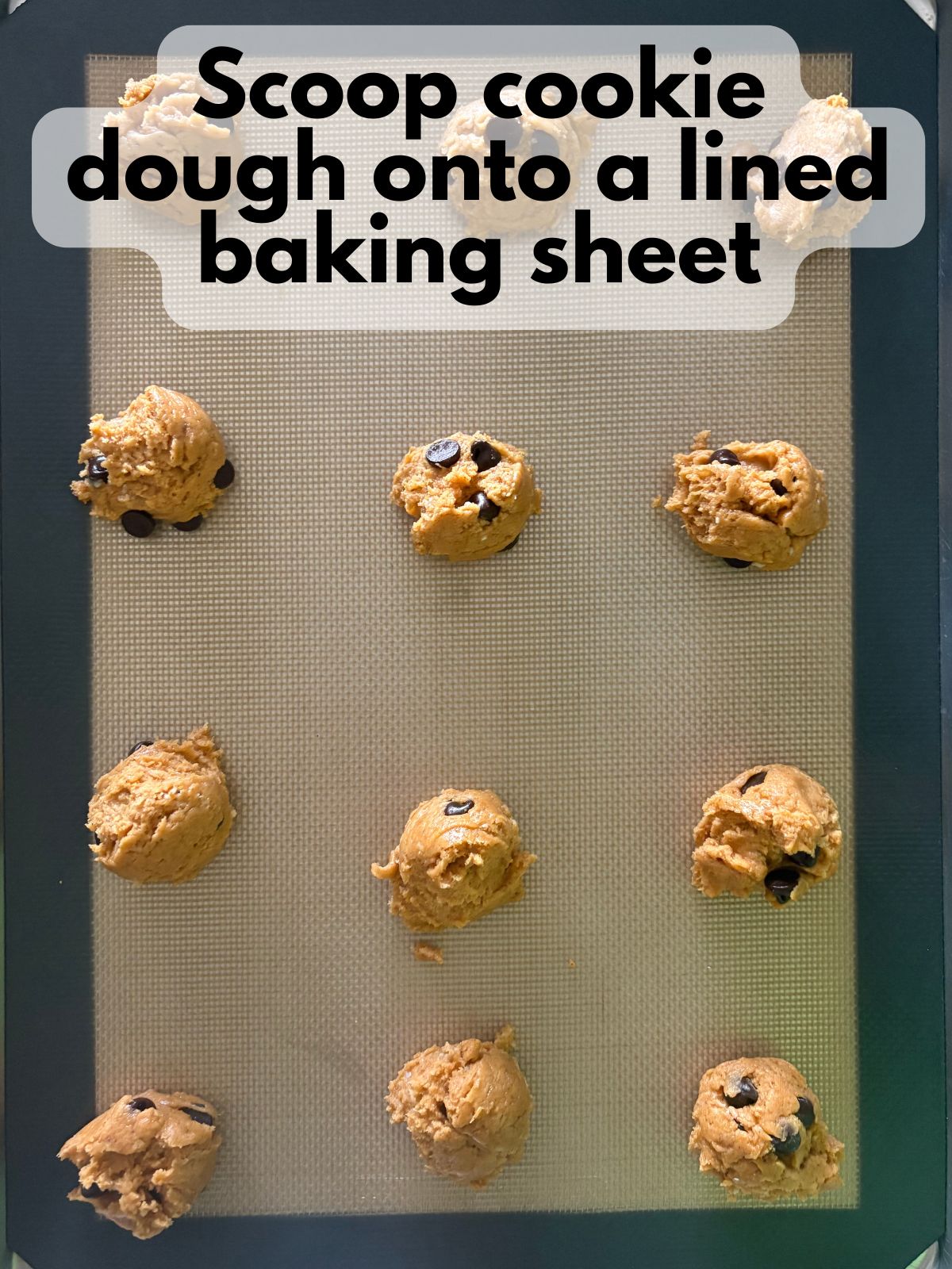 pumpkin chocolate chip cake mix cookie dough scooped on a baking sheet
