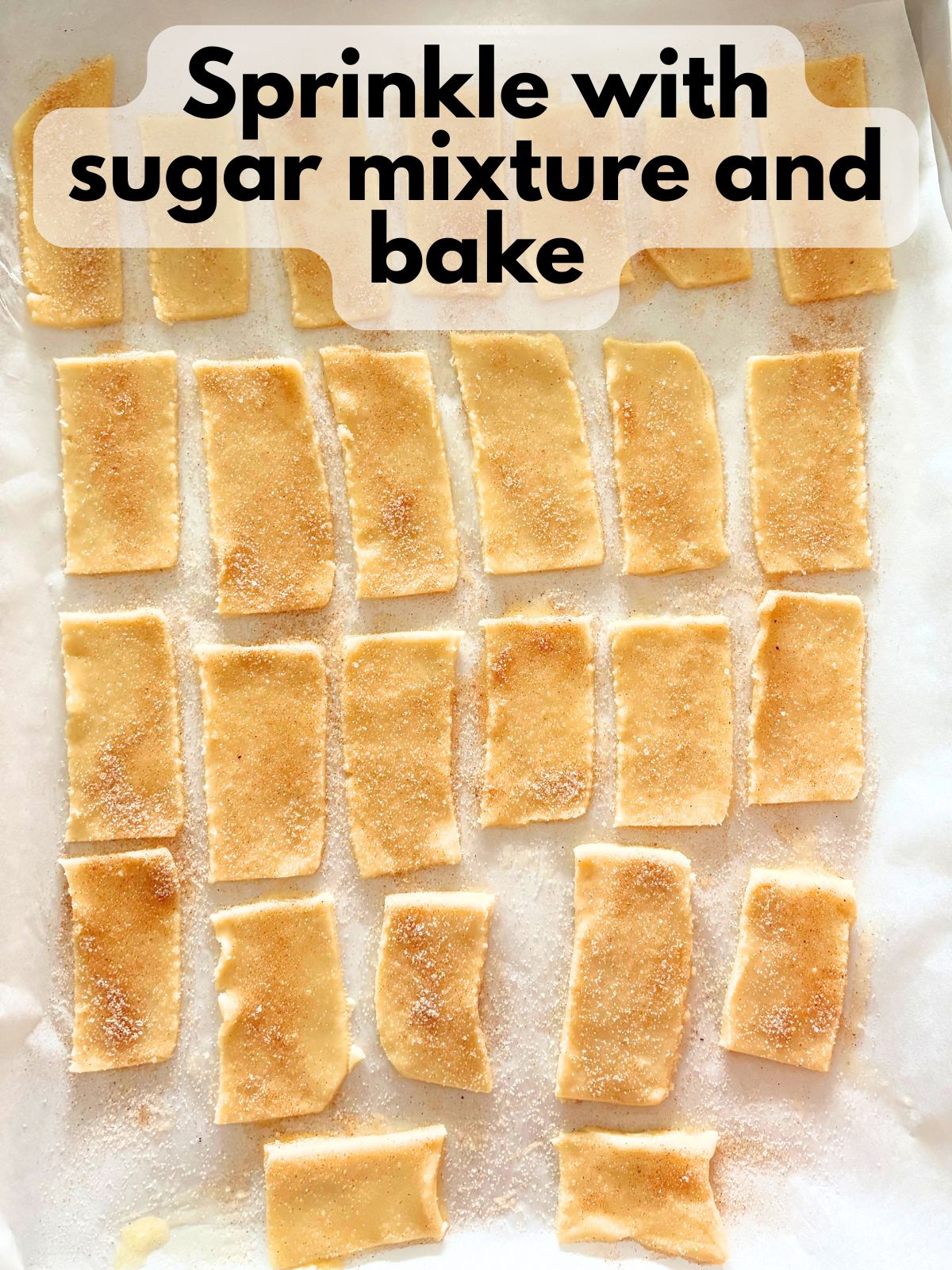 cinnamon sugar sprinkled on top of buttered pie crust pieces