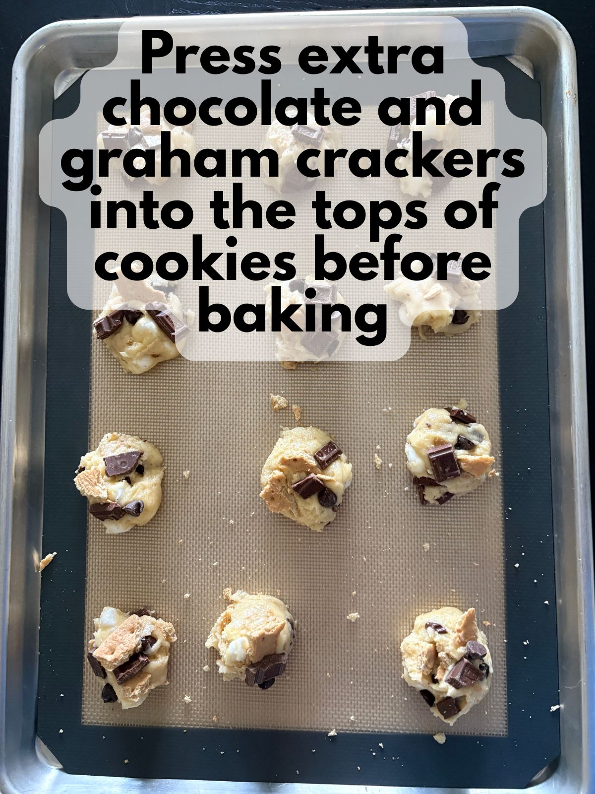 extra chocolate, chocolate chips and graham crackers on top of cookie dough balls