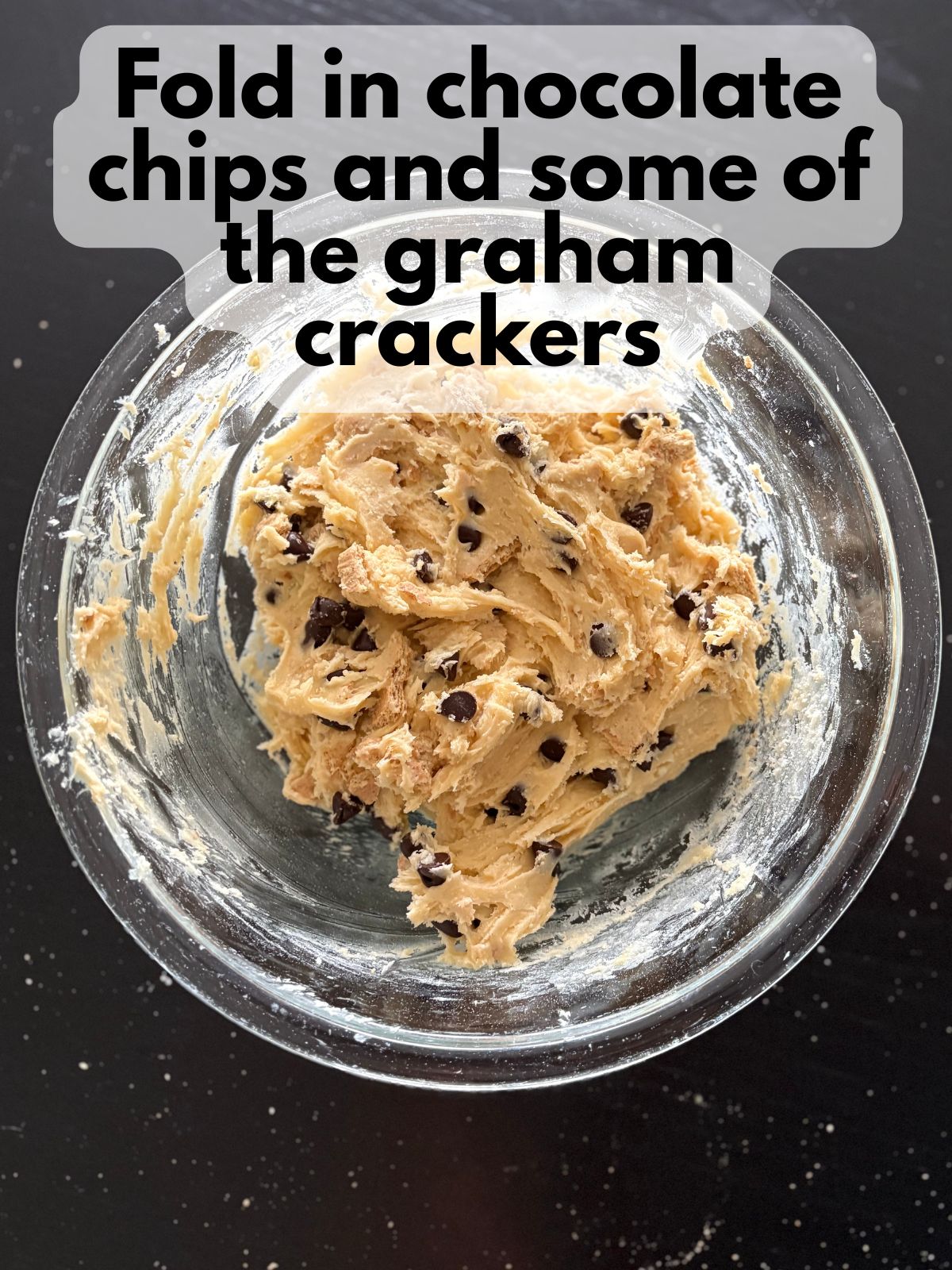 chocolate chips and graham crackers folded into cookie bar dough