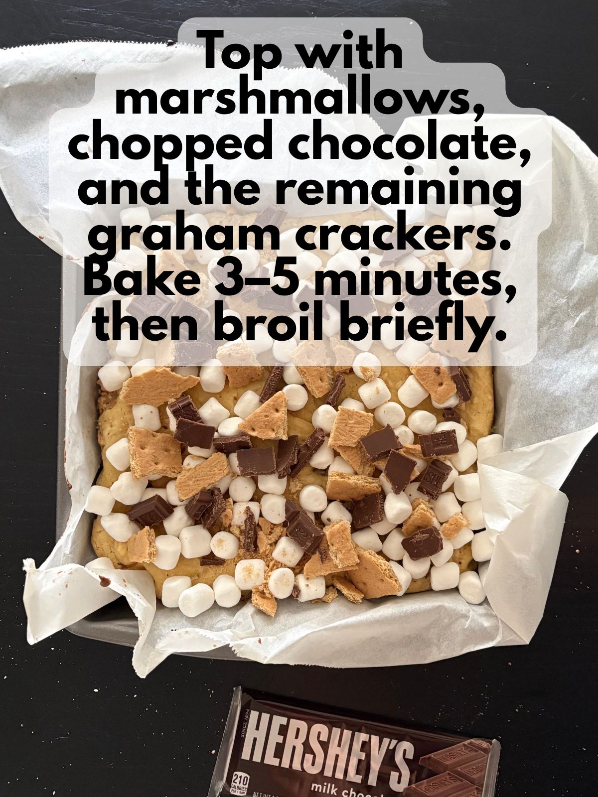 extra graham crackers, mini marshmallows and chocolate pieces sprinkled on top of baked cookie bars