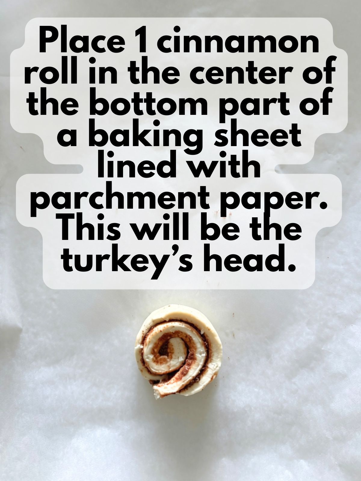 cinnamon roll on a pan lined with parchment paper