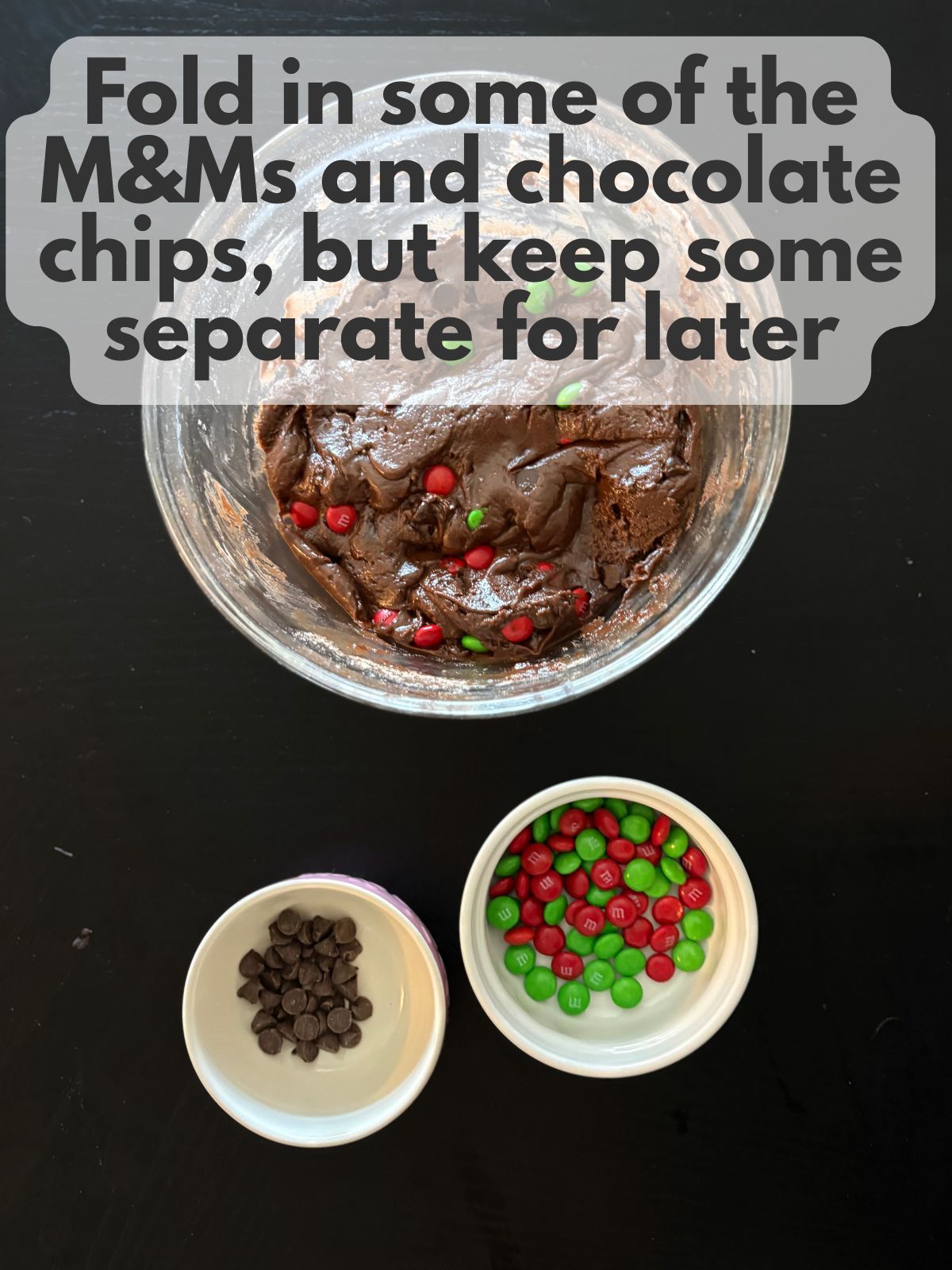 M&Ms and chocolate chips folded into cookie dough, some M&Ms and chocolate chips are kept aside