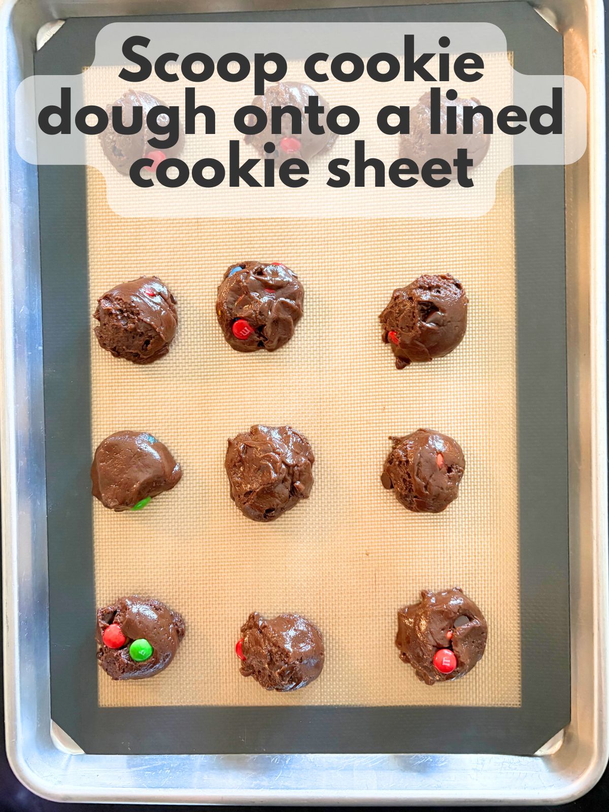 cookie dough scooped on a lined baking sheet