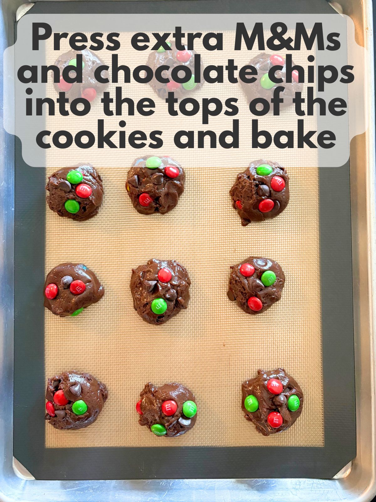 extra M&Ms and chocolate chips pressed into the tops of cookie dough balls