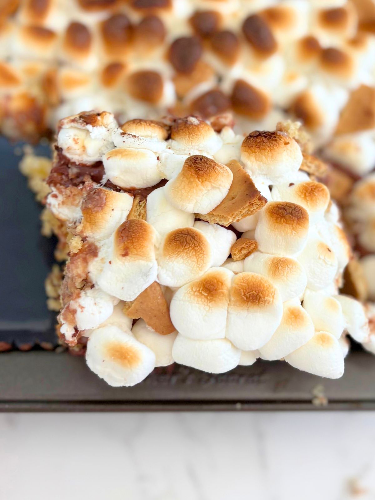 a slice of s'mores poke cake