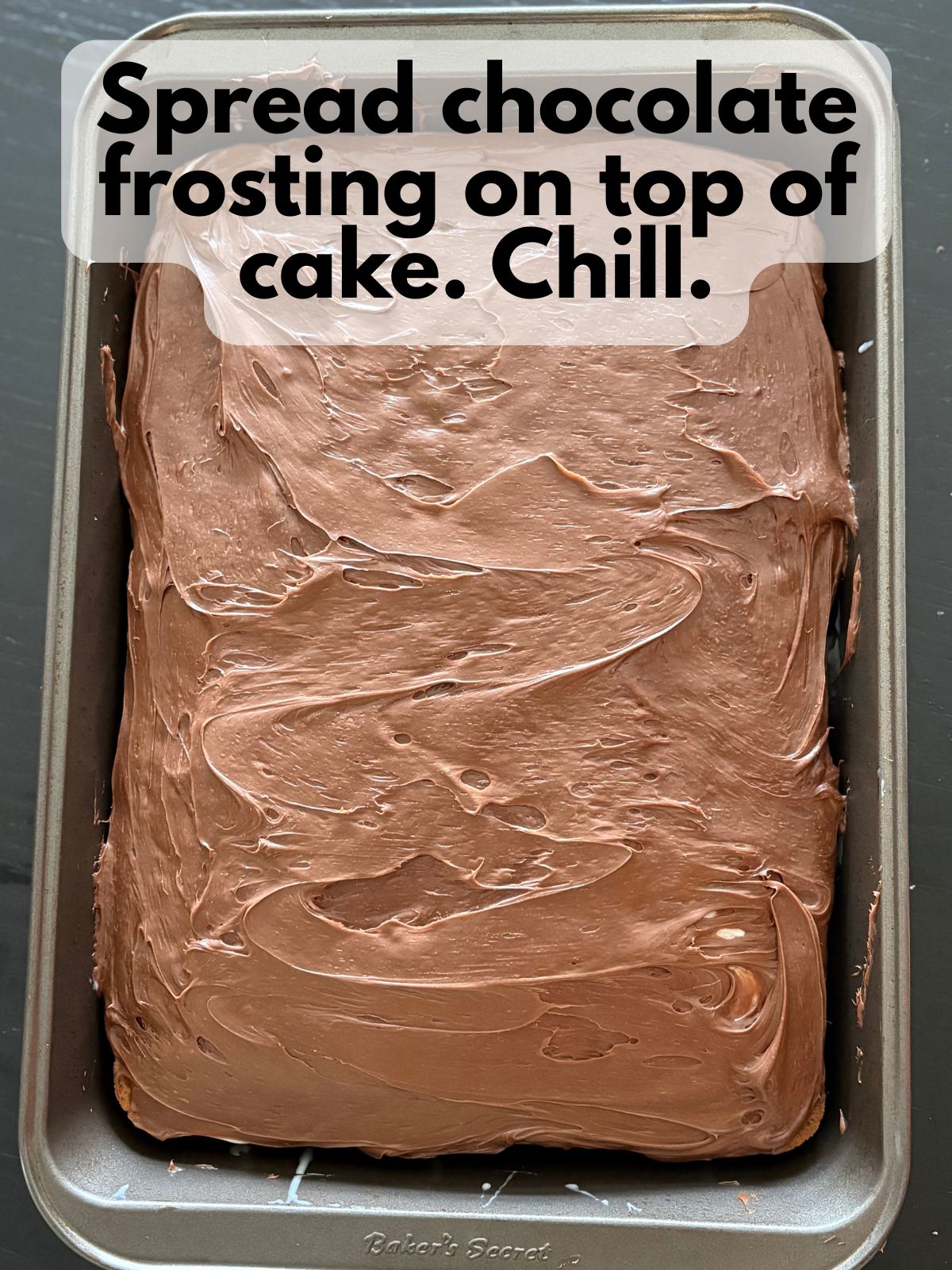 chocolate frosting spread on top of cake with holes in it