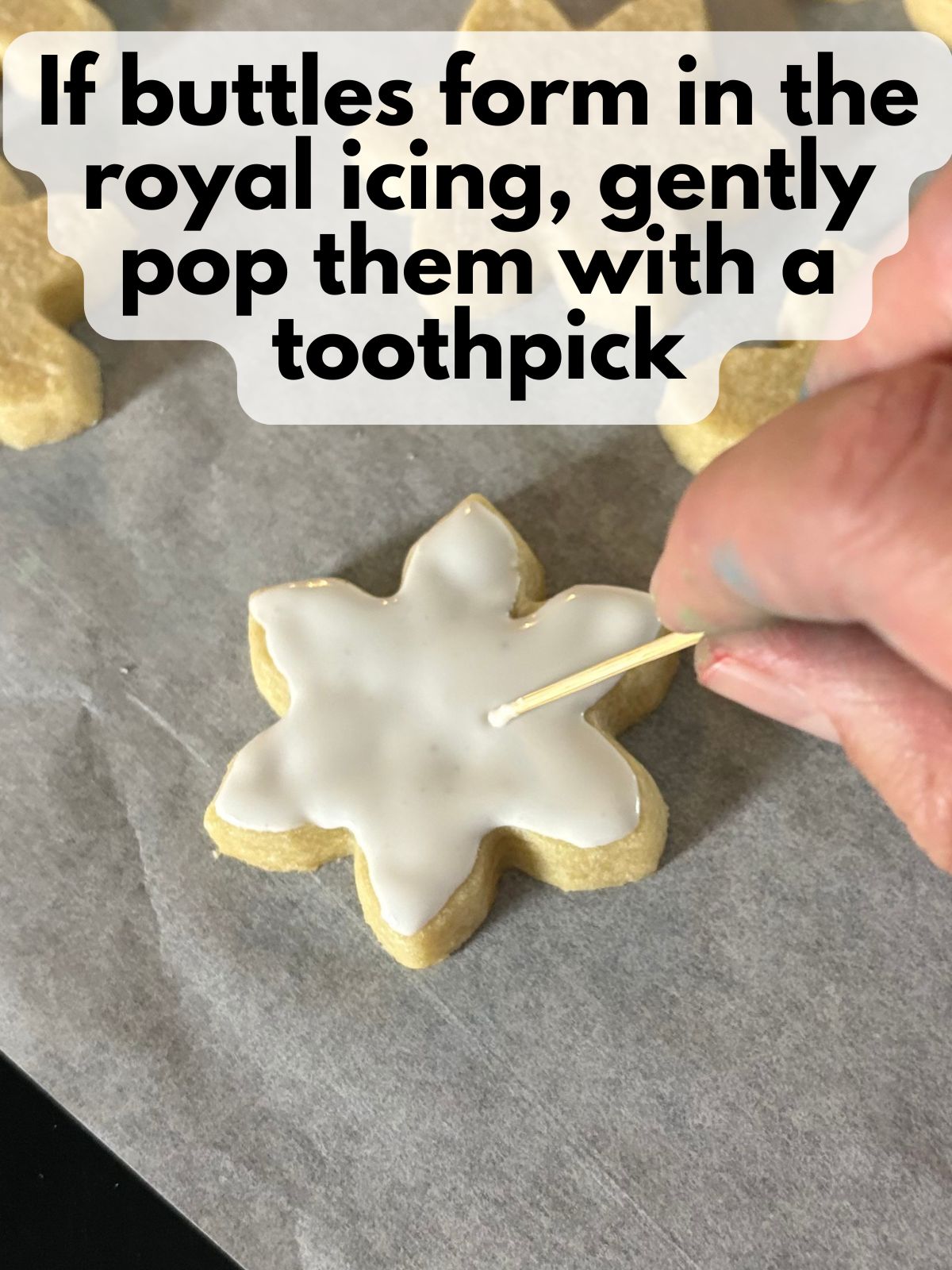 toothpick poking a bubble in royal icing