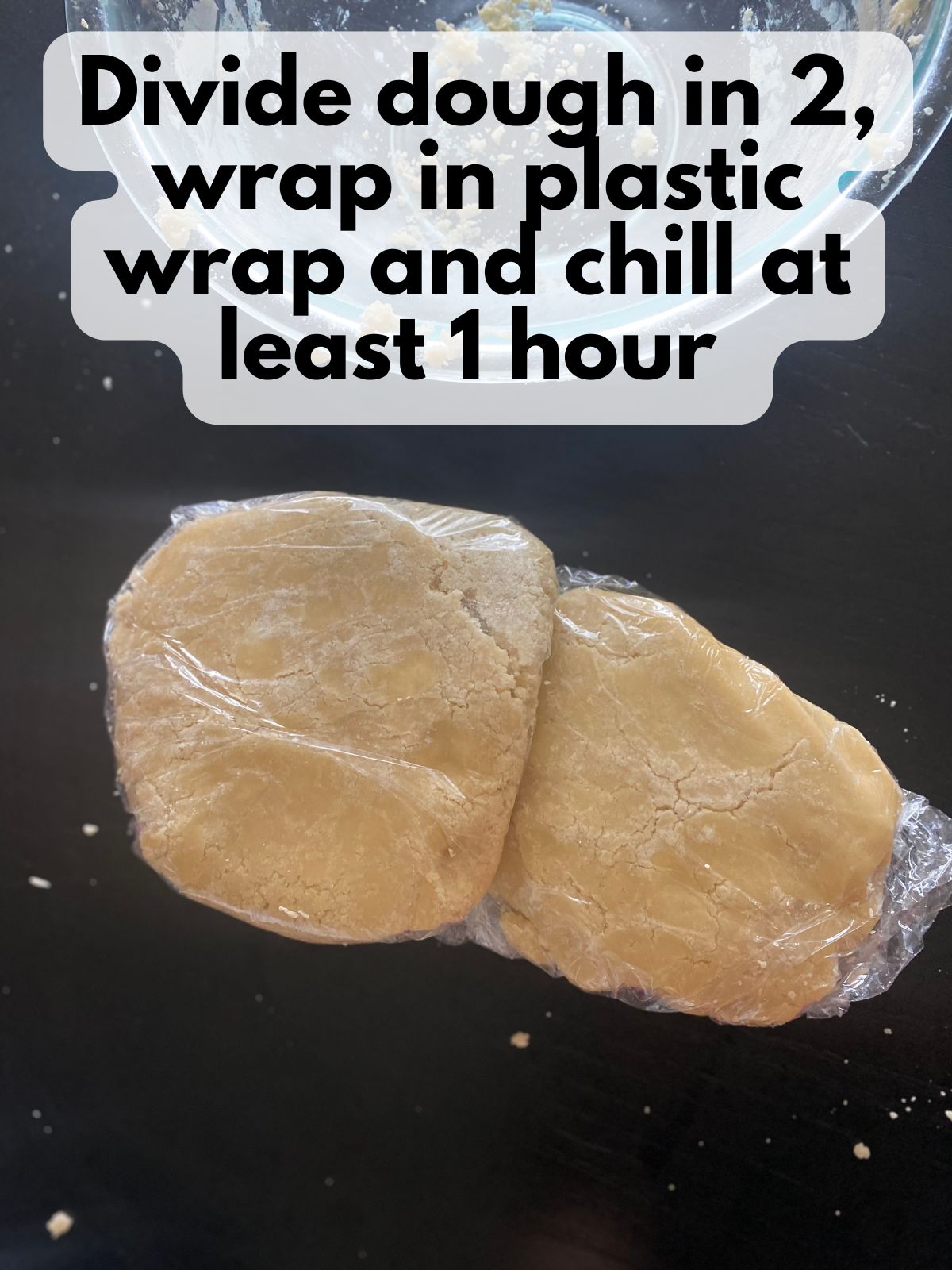 cutout cookie dough divided in 2 and wrapped in plastic to chill