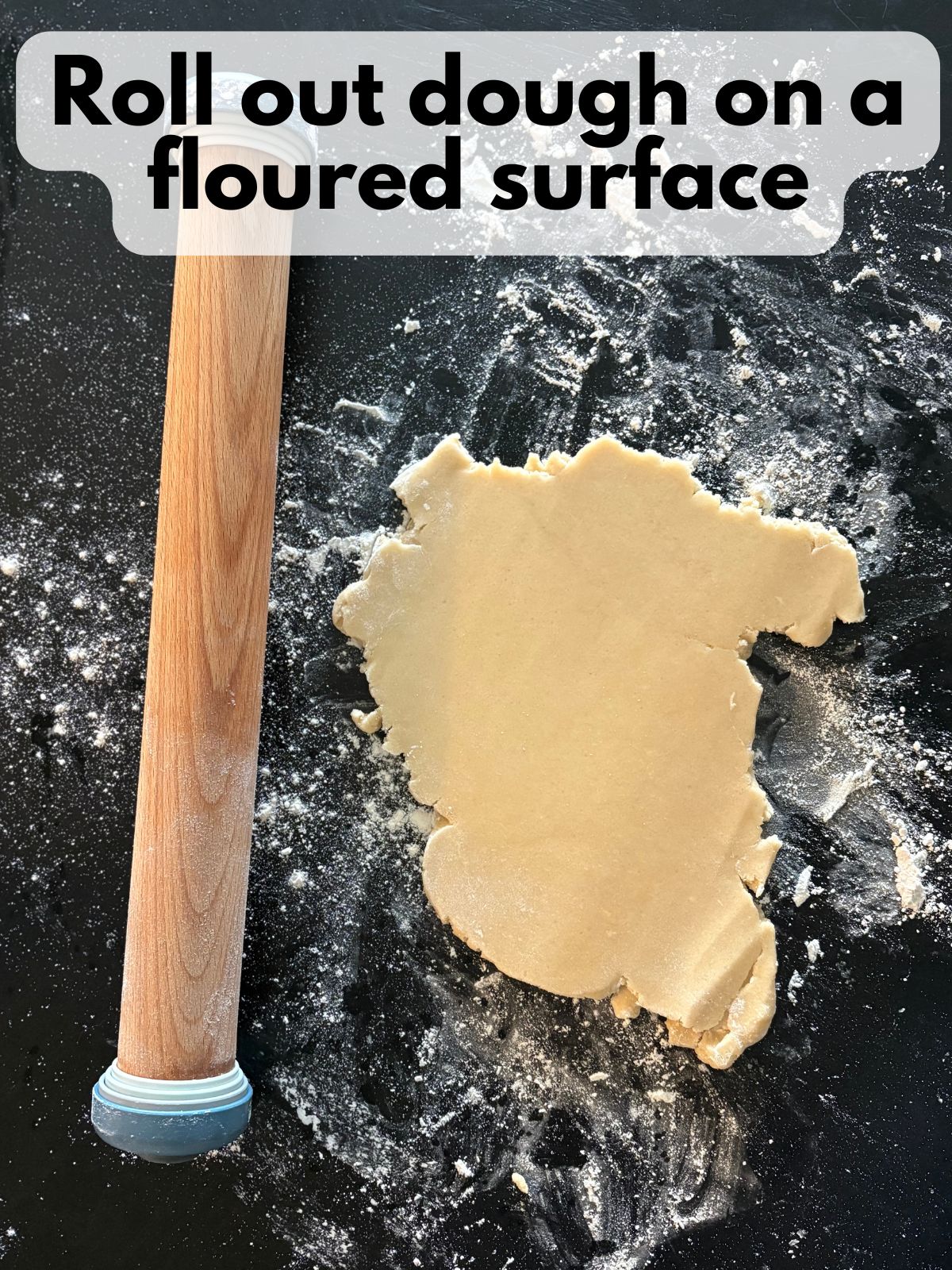 cutout cookie dough rolled out on a floured surface
