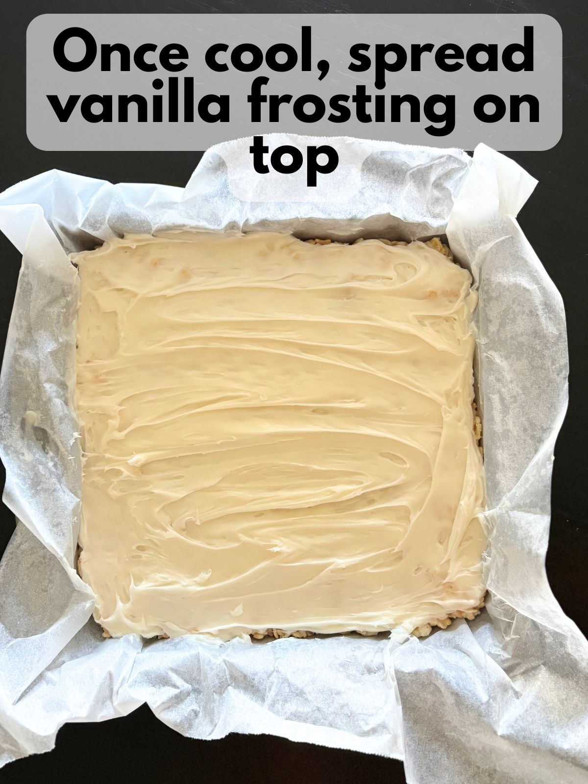 vanilla buttercream spread over the top of brown butter rice krispie treats